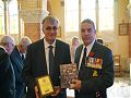 M Vandendriescche received a pair of plaques from General Greg Young